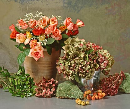 still life with a bunch of roses and dry hortensias