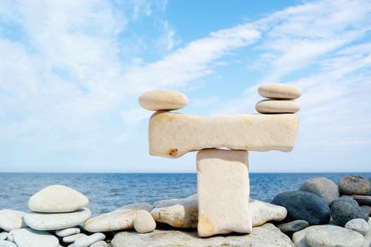 Pile of pebbles in the balance on the seacoast