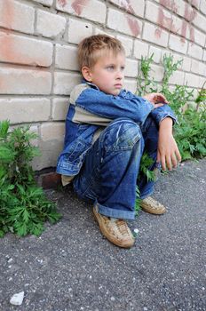 one young man sits against graffiti alone