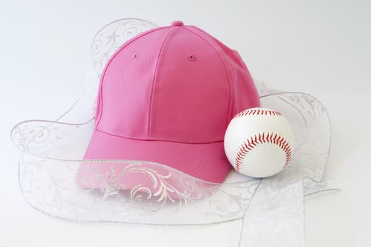 Feminine presentation of a girl's love of baseball; pink cap, white ribbon, and baseball; 