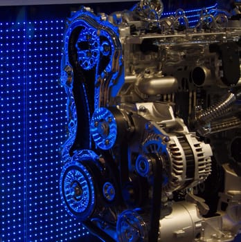 Cut out of motor engine, displayed in front of a blue LED wall