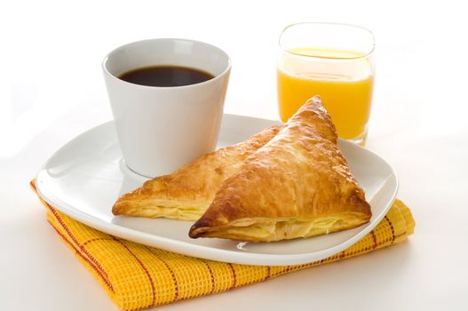 Breakfast of fresh baked apple turnovers and coffee.