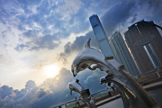 steel dolphins and beautiful sunset in hong kong