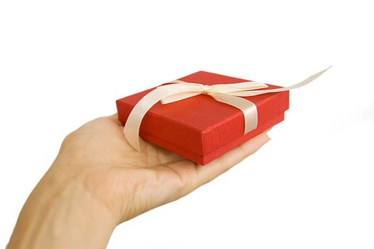 Red gift box in hand isolated on white
