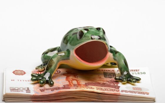 Symbol of riches a frog and a pack of denominations face value of five thousand roubles