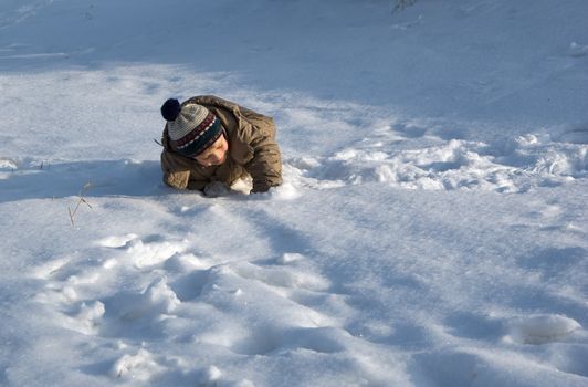 The small child goes for a drive on a snow field