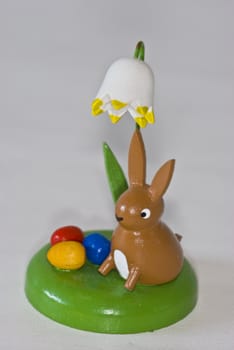 cute easter bunny with colorful eggs under a flower