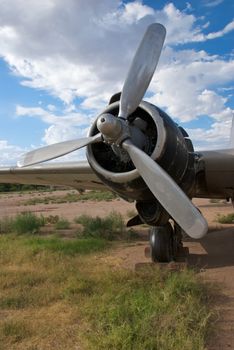 The tri-fin propeller of a World War II bomber that has been abandoned in a storage yard
