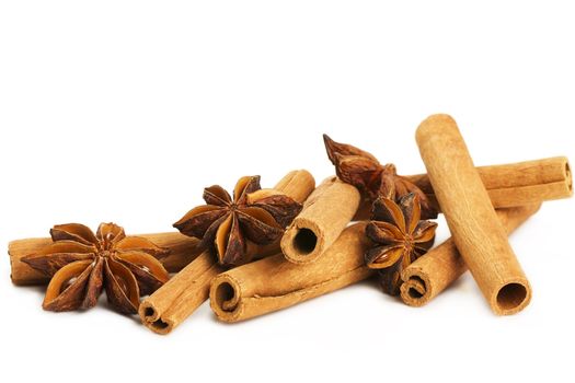 some cinnamon sticks and star anise on white background