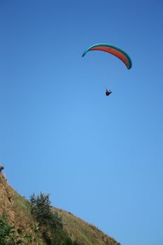 Paraglider Demonstrates Freedom in the Blue Sky 