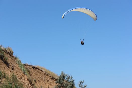 Paraglider Demonstrates Freedom in the Blue Sky 