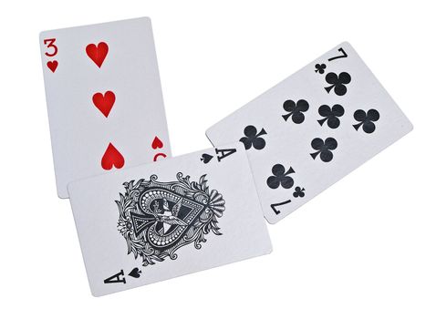 Isolated playing cards three, seven and ace against white background