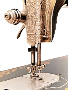 front part of old sewing machine against the white wall