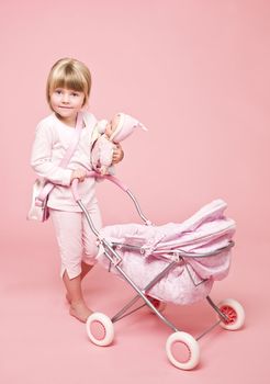 Young girl with Baby Stroller on pink background