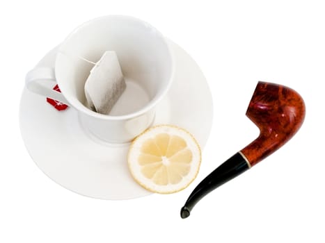 Empty cup with spoon piece of  lemon and pack of tea