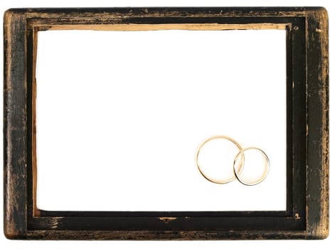 vintage wooden frame and two wedding rings with copyspace for your text