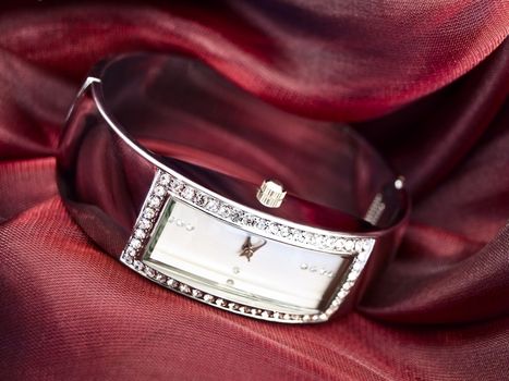 lady clock at wine-colored textile