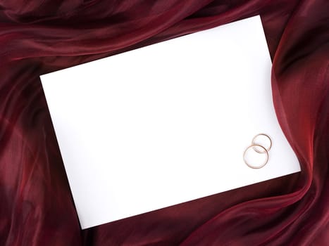 Silk with white frame and two wedding rings with copyspace for your text