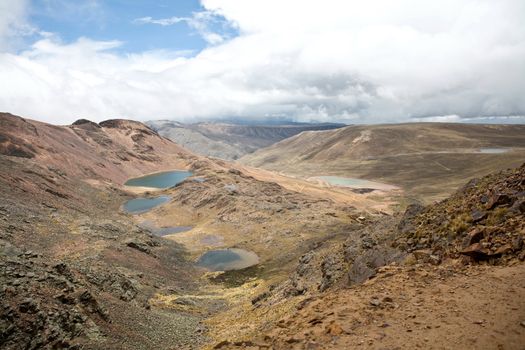 Chacaltaya is a glacierial mountain range in Bolivia with an elevation of 5421m and a view of Lake Titicaca in the distance.