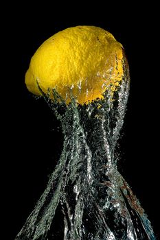 Lemon in water splashes on a black background
