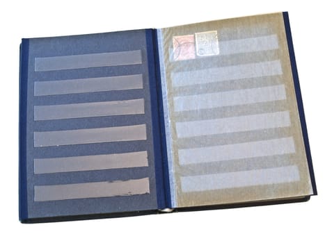 Isolated stamp album with some stamps against the white background