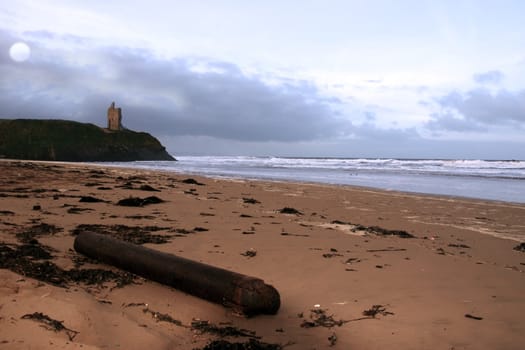 driftwood on ballybunion beach on the west coast of ireland at night