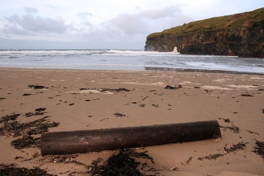 driftwood on ballybunion beach on the west coast of ireland at night