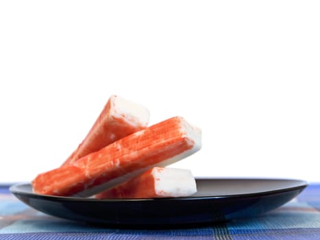 crab sticks at plate against the white background