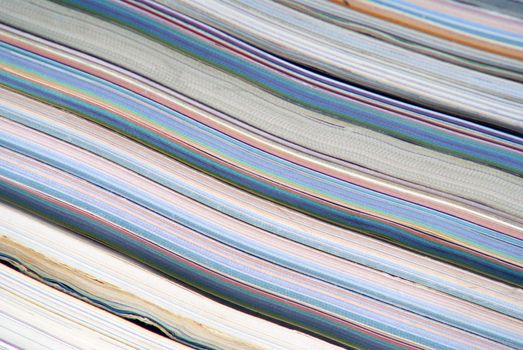 stack of colorful magazines or documents - paper edges background