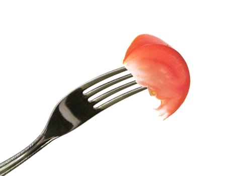 Tomato slice at fork against the white background