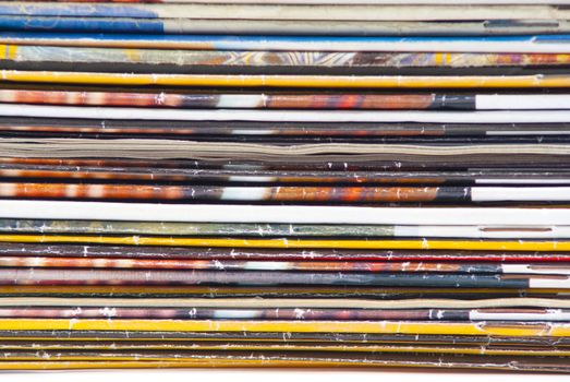 stack of colorful magazines or documents - paper edges background