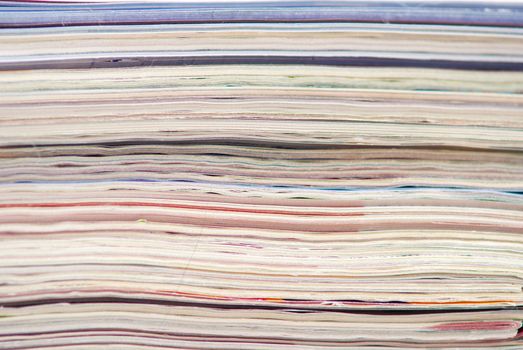 stack of colorful magazines or documents - paper edges background