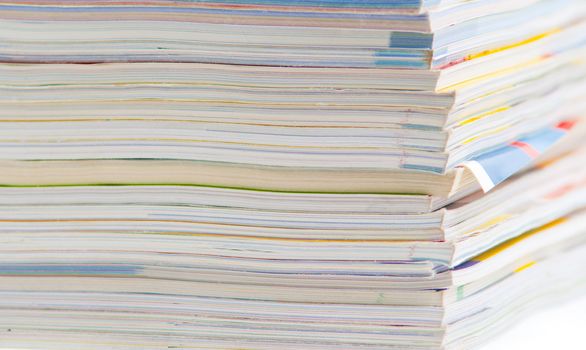 stack of colorful magazines or documents - paper edges background