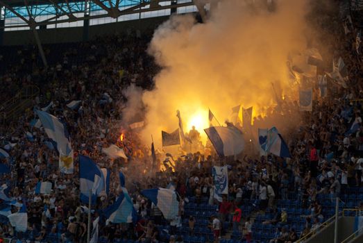 supporters burn flares