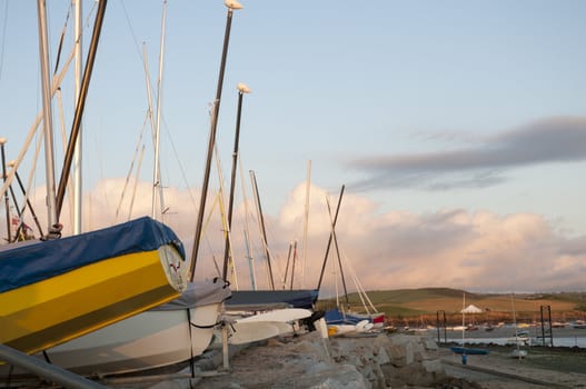 Low angle shot of small boats hulls against evening sky, docked in Rock, Cornwall, UK