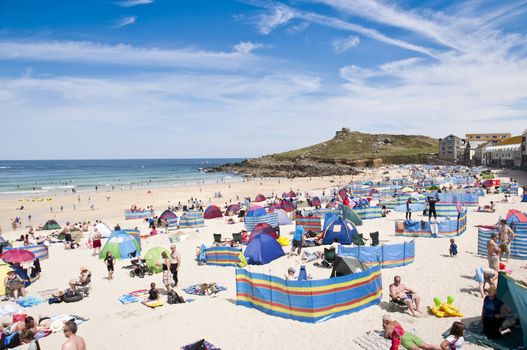 SAINT IVES, CORNWALL - AUGUST 8: Tourists and locals enjoy the beach in St. Ives, in Cornwall, Southern UK August 8, 2010 in Saint Ives, Cornwall, UK.
