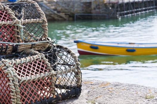 Detail of crab cages with small vessel in the background.