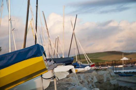 Low angle shot of small boats hulls against evening sky, docked in Rock, Cornwall, UK