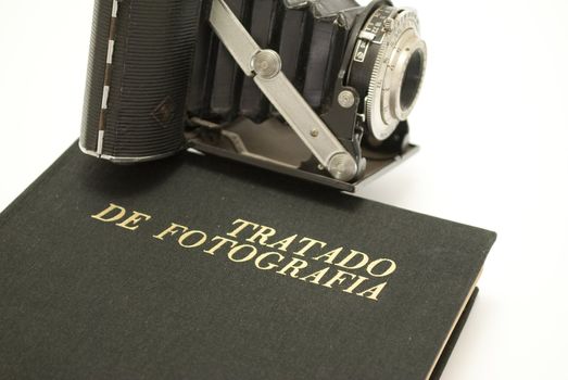 Old photo camera on book