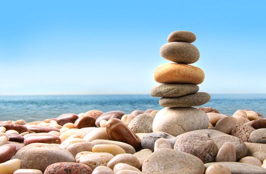 Stack of pebble stones on white background