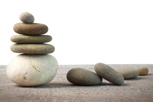 Stack of spa rocks on wood with white background