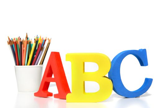 ABC letters with pencils on white background