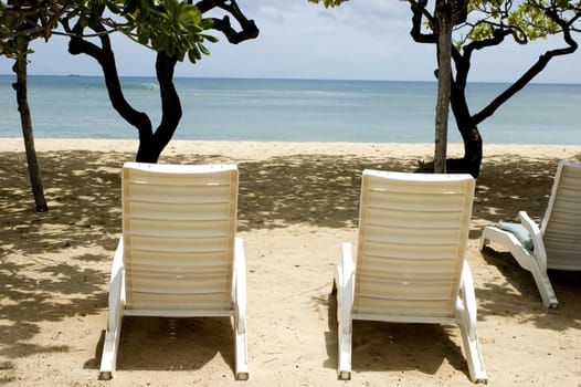 Indonesia, Bali Island, holiday resort in NusaDua. Beautiful beach with green palms and blue ocean water.