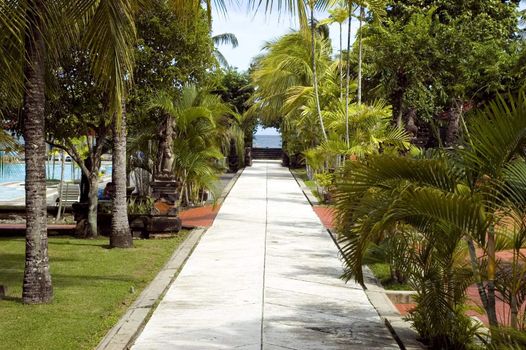 Bali Island, Nusa Dua holiday resort, Indonesia. Path from hotel to the beach with beautiful, blue ocean far at the end.