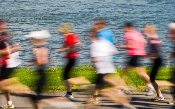 Photograph from a marathon, where the calm sea and green background is probably not noticed by the contestants.