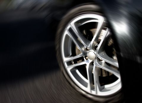 Closeup photo of the front car rim, with a radial motion effect.