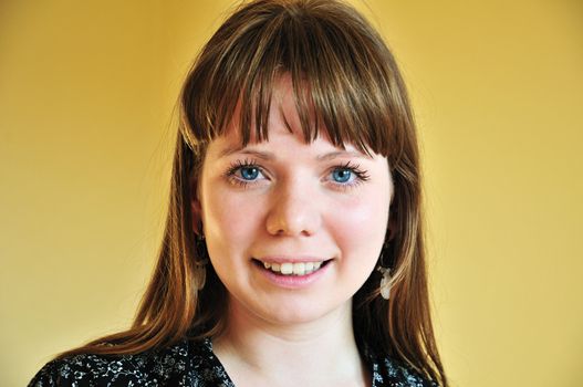 portrait of cheerful girl with yellow background