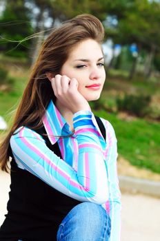 thoughtful sweet girl in the park in spring time