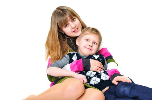 funny brother and sister sitting together over the white