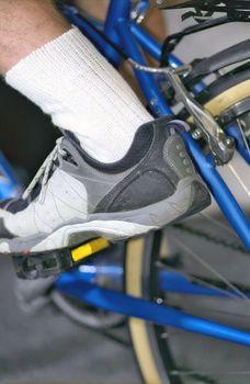Man's leg on pedal of cycle close up